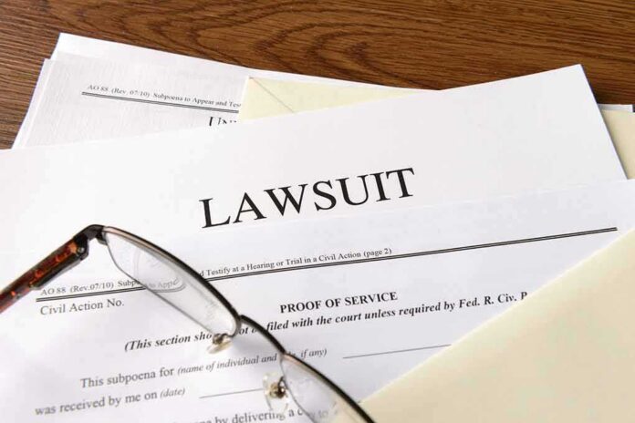 Legal documents labeled lawsuit on a desk