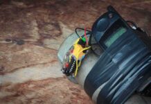 improvised device with phone and wires taped to a metal cylinder