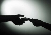 hands exchanging cash