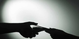 hands exchanging cash