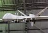 SHOCKING Pivot: Drone Battalion Shut Down military drone with missiles suspended in a hangar