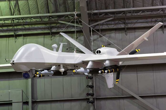 military drone with missiles suspended in a hangar