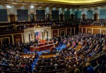 Bipartisan Push Risks Anonymity Crackdown legislative chamber filled with seated members during a session