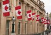 Ottawa’s $11B Icebreaker Gambit Canadian flags on a neoclassical building facade