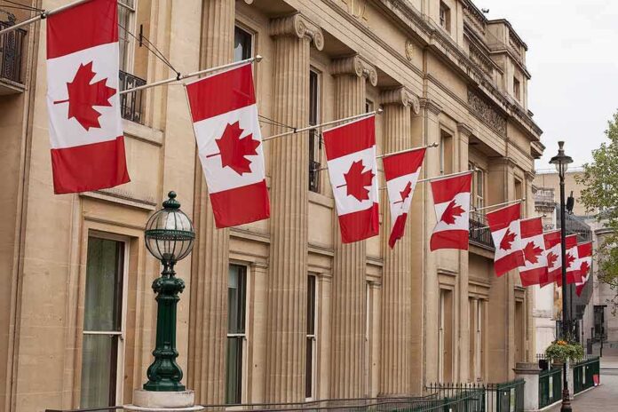 shutterstock_1232918848 Canadian flags on a neoclassical building facade