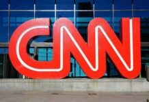 Bizarre Shout-Out: Trump Hypes CNN Analyst CNN red logo sculpture outside a glass-fronted building