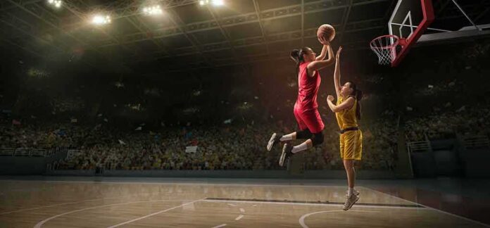 shutterstock_1411326926 Two basketball players contest a layup under the hoop