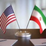 United States and Iran desk flags on a stand