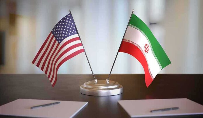 shutterstock_1609200817 United States and Iran desk flags on a stand