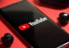 FTC Targets YouTube: Rulebook on Trial smartphone displaying YouTube logo on red background
