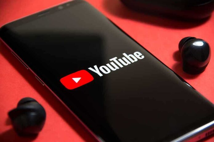 shutterstock_1771462121 smartphone displaying YouTube logo on red background