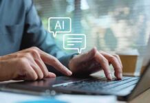 Hands typing on a laptop with AI chat icons