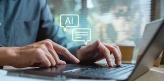 Hands typing on a laptop with AI chat icons