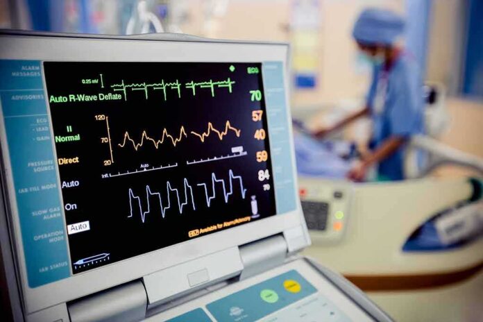 shutterstock_414452563-1 Patient monitor displaying vital signs in a hospital room