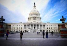 United States Capitol building with visitors on the plaza