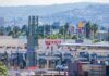 Police Hit Plot Triggers Lockdown Border crossing booths at Mexico entry point with cityscape in background