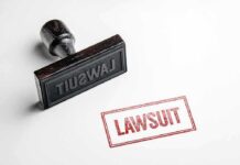 Prediction Markets Under Fire In NY Rubber stamp with red lawsuit imprint on white paper