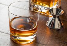 Whiskey in a rocks glass on a wooden table