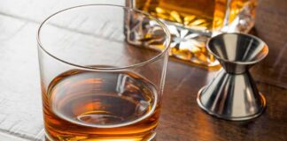 Whiskey in a rocks glass on a wooden table