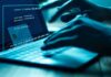 Hands typing on a laptop with cybersecurity login overlay