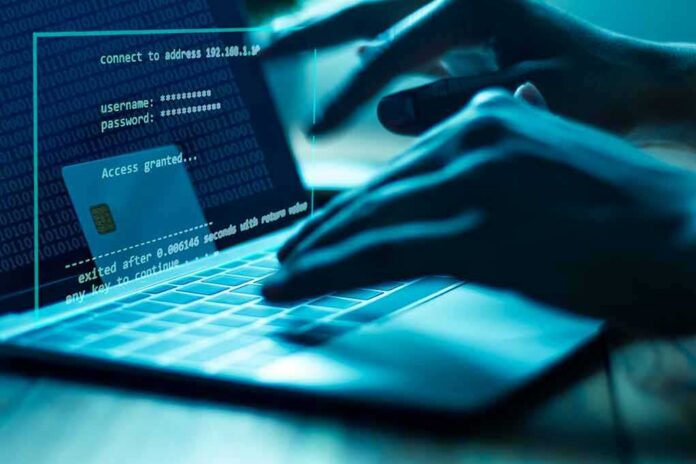 shutterstock_1107463670 Hands typing on a laptop with cybersecurity login overlay