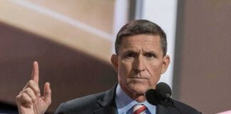 Michael Flynn speaking at a podium with a raised finger gesture