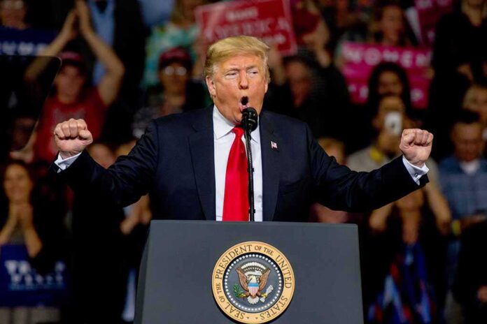 Topeka,Kansas,,Usa,,October,6,,2018,President,Donald,Trump,At Donald Trump speaking at a rally podium with arms raised