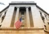 American flag hanging on a neoclassical government building