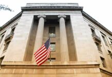 American flag hanging on a neoclassical government building