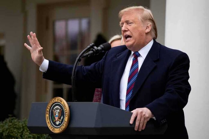 shutterstock_1276349437 Donald Trump speaking at a podium outdoors