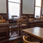 Empty jury box in a courtroom with wooden chairs
