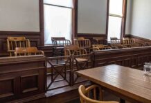 Empty jury box in a courtroom with wooden chairs