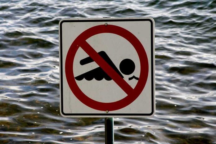 No swimming sign by the water