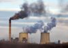 Massive EPA Rollback Sparks Lawsuit Frenzy Industrial power plant with smokestack and cooling towers emitting smoke