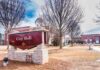 Taxpayer Cash Trails Hit Dictator’s Family City Hall sign in front of a red-brick municipal building