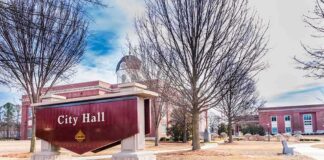 City Hall sign in front of a red-brick municipal building