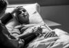 Grandma’s Death Sparks Criminal MAiD Investigation Patient in hospital bed with nasal oxygen held by visitor