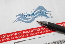 Trump’s Mail Vote Crackdown Sparks Legal Firestorm Official election mail envelope with pen