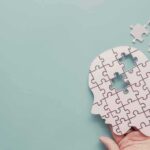 Under Oath: Autism Link Shattered human head puzzle silhouette with missing pieces