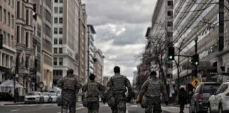 soldiers walking down a city street