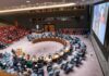 War Powers Showdown Erupts In Congress Delegates seated around a circular conference table in a large chamber