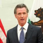 California Preps AI Shutdown Playbook man in suit speaking at podium