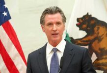 California Preps AI Shutdown Playbook man in suit speaking at podium