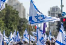 Israeli flags waved at a street demonstration