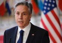 U.S. Envoy Explodes: No Israel Strike Notice Antony Blinken speaking at a podium with U.S. flag in background