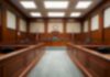 DOJ Nails Bizarre Voter Registration Plot Empty courtroom with wooden benches and judge's bench