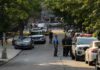 Horrific Apartment Attack Shocks Brazil Police officers secure a residential street with patrol cars and yellow tape