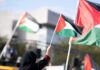 Yankee Stadium Erupts Over Flag Sprint Person waving a Palestinian flag at a rally