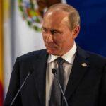 Putin’s Stark Warning Rattles Europe Vladimir Putin at a podium during a formal event