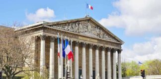 Neoclassical building with columns and French flags
